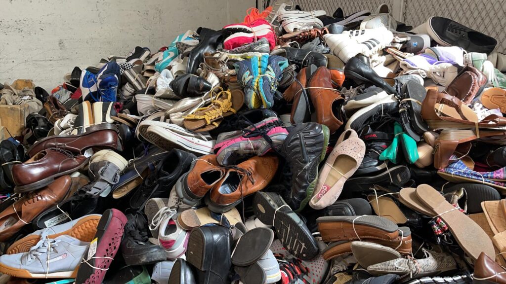 A pile of shoes stacked on top of each other.